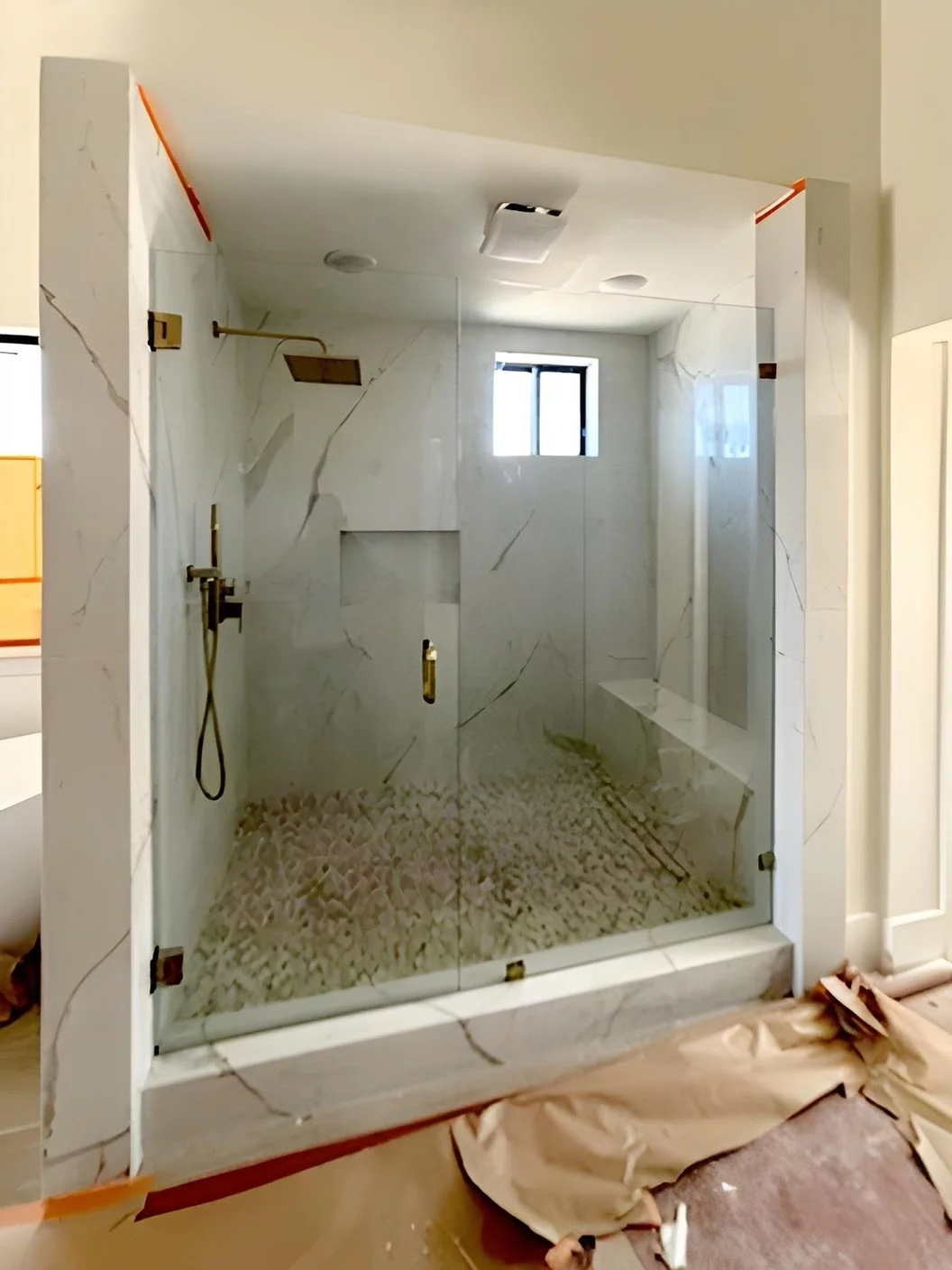 Frameless custom shower enclosure with gold handle and clips, for Murrieta, CA bathroom remodel